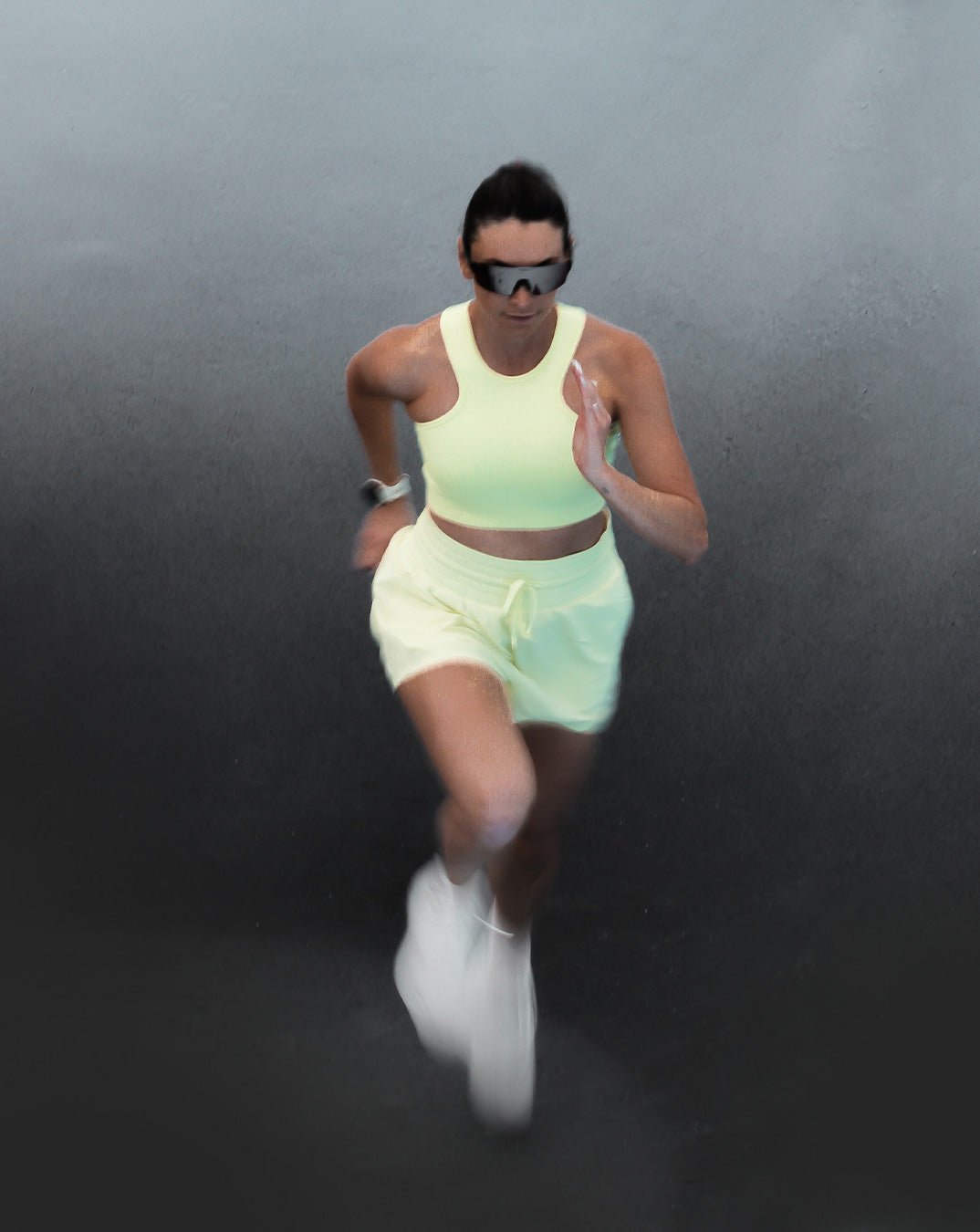 Sustainable light yellow and green longline sports bra for running and high impact with matching shorts