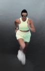 Sustainable light yellow and green longline sports bra for running and high impact with matching shorts